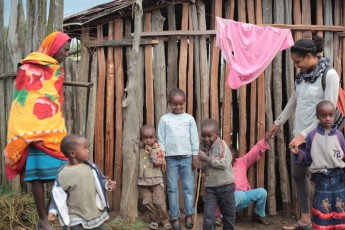 Brooke with Samburu kids next to a house