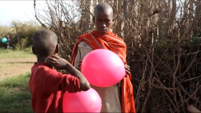 Kids holding baloons next to Sadhan Forest Kenya land
