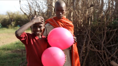 Kids holding baloons next to Sadhana Forest Kenya
