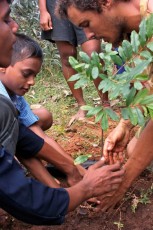 Tiago and children planting a tree