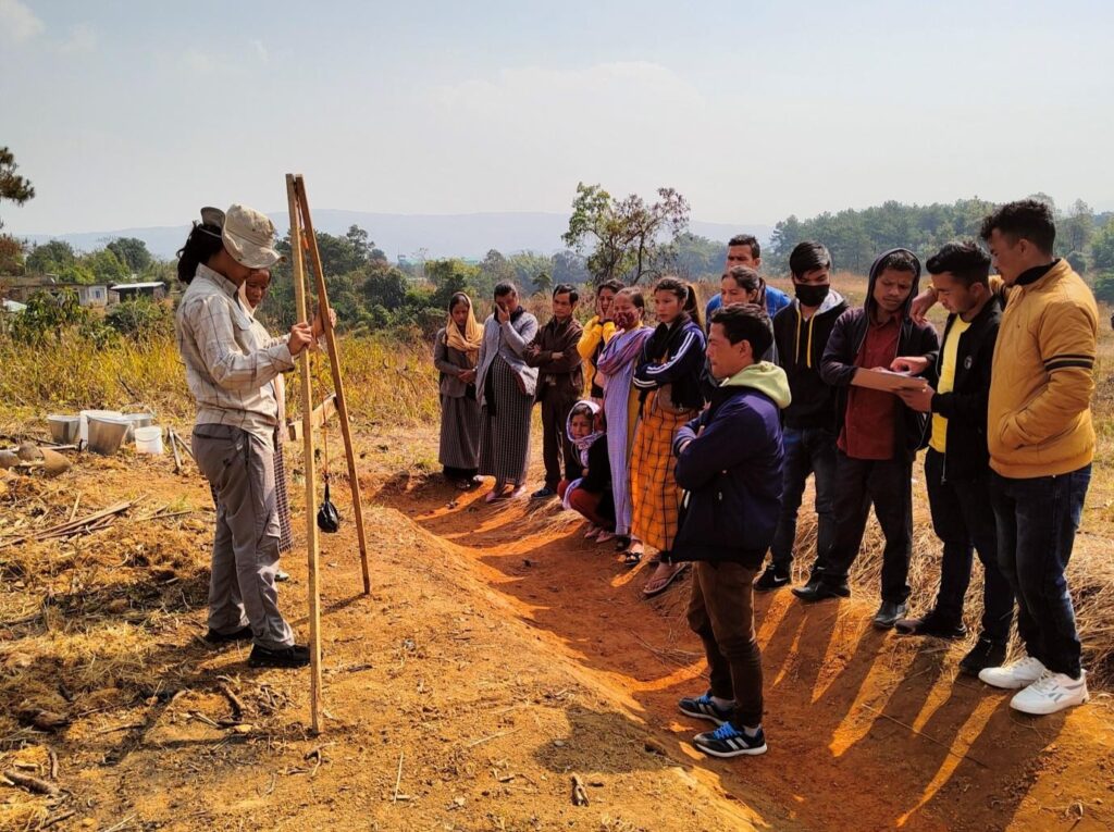 Showing local people in Meghalaya how to use an A-frame to make a swale