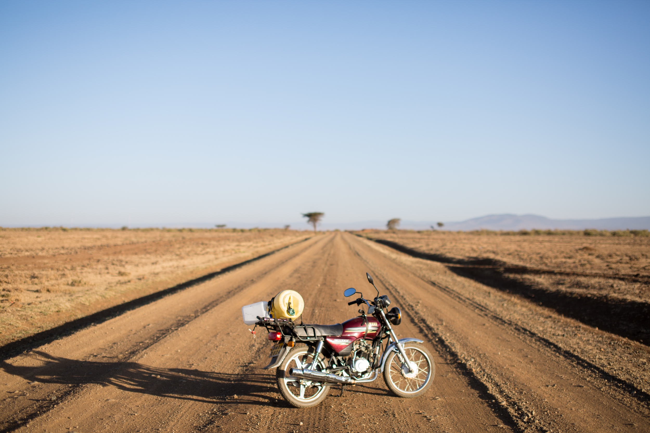Motorbike on a gravel road in wide open barren landscape