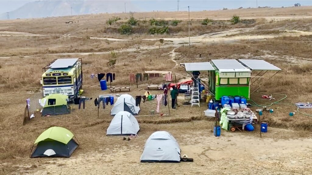 The mobile reforestation unit setting up camp in Meghalaya, comprised of two buses