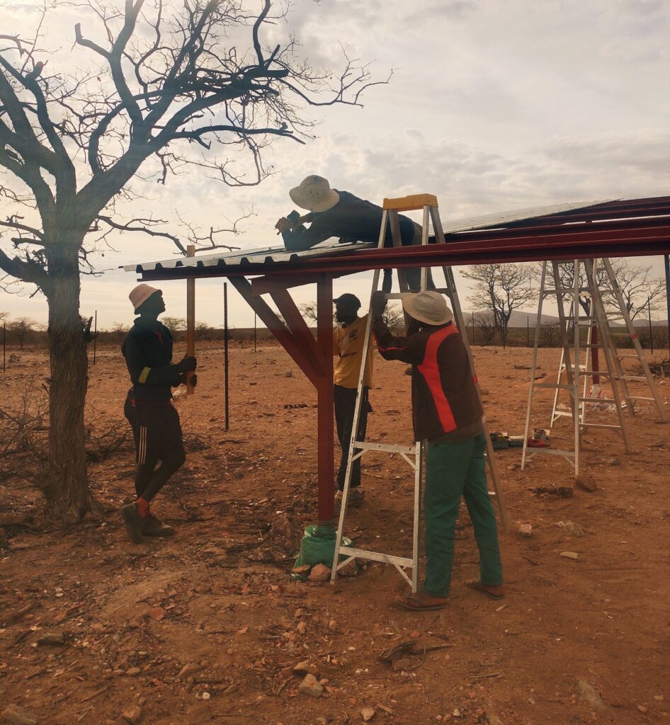 Team in Namibia constructing a metal frame with metal roofing sheet